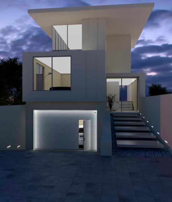 Maison moderne de nuit. La porte de garage est de type sectionnelle et est blanche.